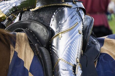 Close up of a medieval knight wering armour sitting on horsebackの写真素材