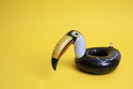 Pelican summer inflatable holiday pool toy against a bright yellow background