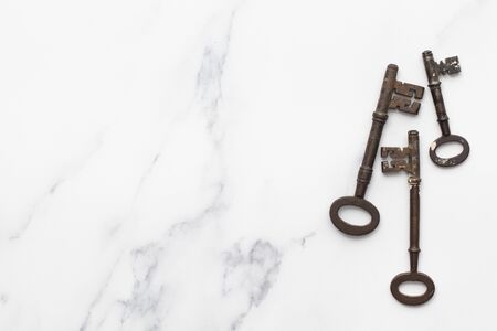 Vintage old fashioned keys on a marble background with copy space