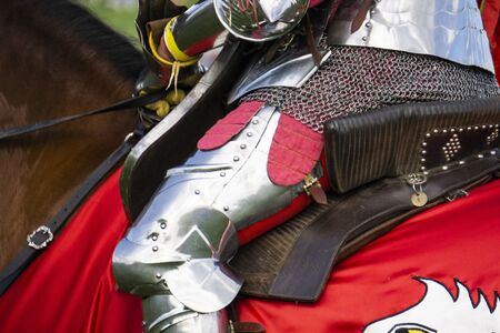 Close up of a medieval knight wering armour sitting on horseback