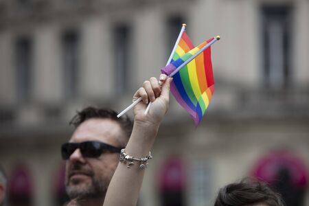 LONDON, UK - July 6th 2019: People wave LGBTQ gay pride flags at a solidarity march