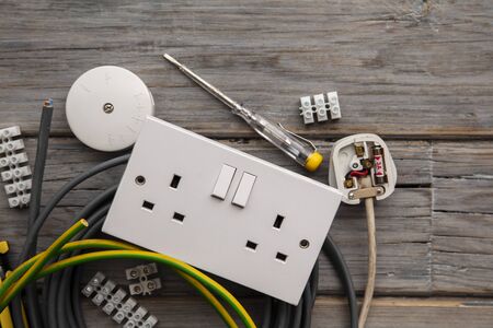 Electrical tools and equipment on a wooden backgroundの写真素材