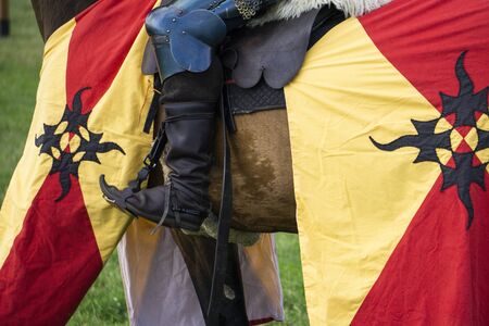 Close up of the foot of a medieval knight on horseback