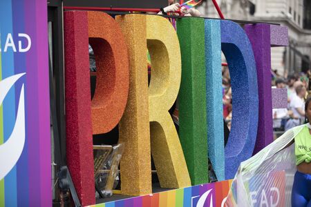 LONDON, UK - July 6th 2019: Pride word in gay pride rainbow colours on the side of a pride festival floatのeditorial素材