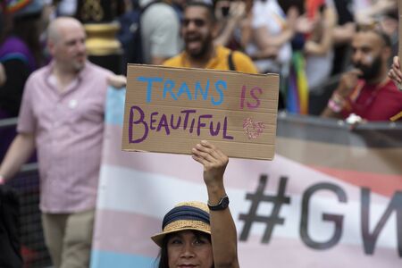 LONDON, UK - July 6th 2019: A person holding a Trans is beautiful sign at a pride event in Londonのeditorial素材