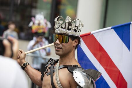 LONDON, UK - July 6th 2019: A man wearing a crown with a union jack at a gay pride eventのeditorial素材