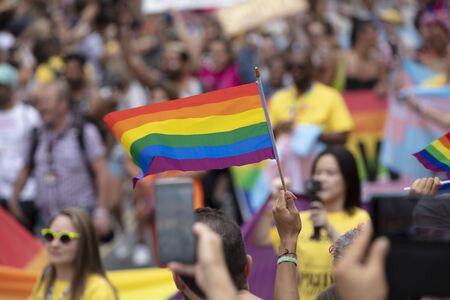 LONDON, UK - July 6th 2019: People wave LGBTQ gay pride flags at a solidarity marchのeditorial素材