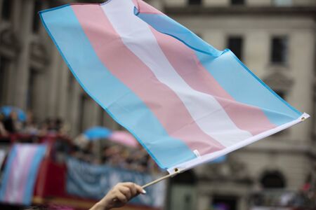 A transgender flag being waved at LGBT gay pride marchの写真素材