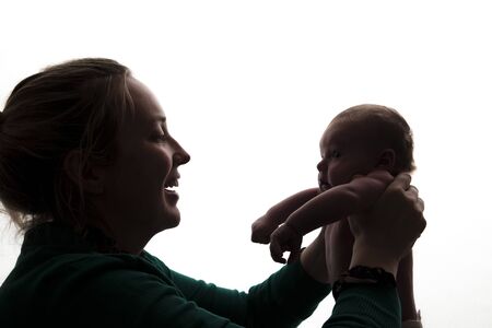 Silhouette of a mother holding her newborn baby