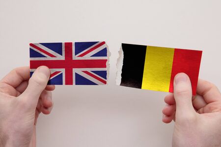 UK and Belgium paper flags ripped apart. political relationship conceptの写真素材