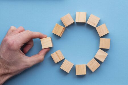 Hand choosing a wooden block from a set. Business choice concept