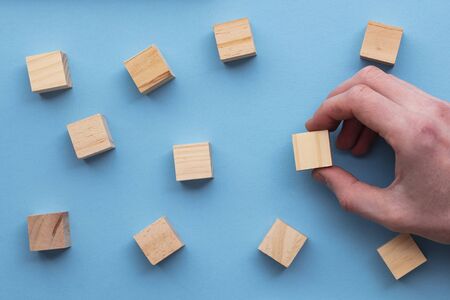 Hand choosing a wooden block from a set. Business choice concept