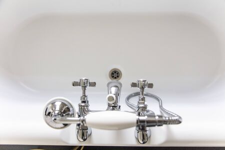 Luxury bathroom interior with classic rolltop bath tub and vintage tapの写真素材