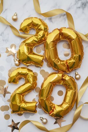 New Year 2020 celebration. Gold foil party balloons with decorations