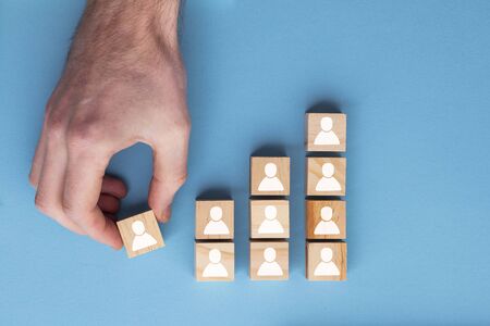 Hand adding a new team member to a group. Business management conceptの写真素材