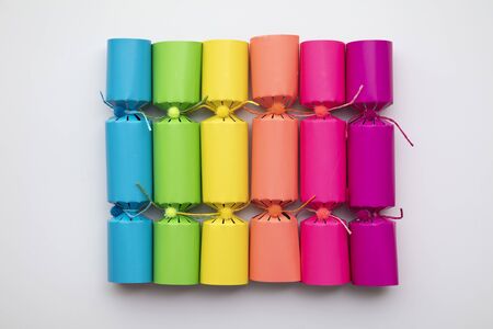 Bright colourful Christmas crackers on a plain background.の写真素材