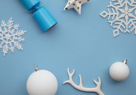 Christmas composition. Festive cracker with winter snowflake, antler and ballsの写真素材