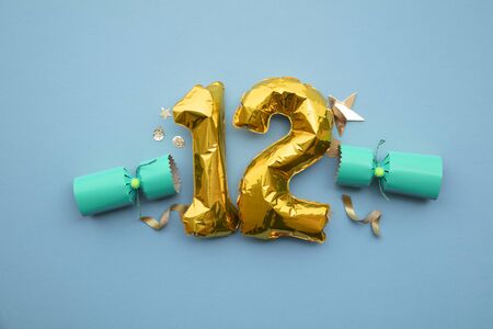 Christmas countdown. Gold number 12 with festive cristmas cracker decorationsの写真素材
