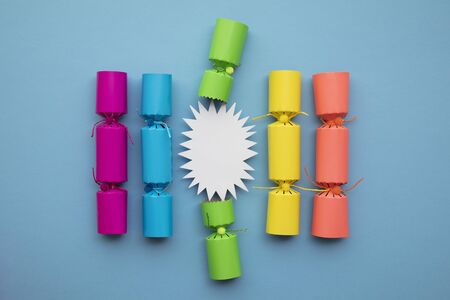 Bright festive christmas crackers on a blue backgroundの写真素材