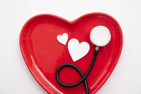 Red heart shape with a stethoscope. Healthy heart conceptの写真素材