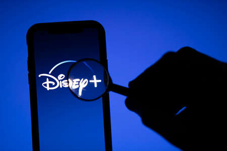 LONDON, UK - April 17 2020: Disney streaming service logo under a microscope