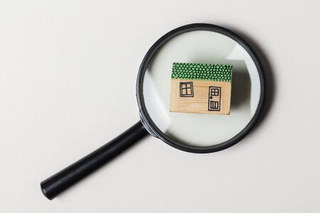 House model with magnifying glass. Property search conceptの写真素材