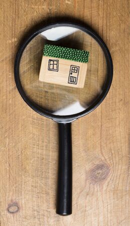 House model with magnifying glass. Property search conceptの写真素材