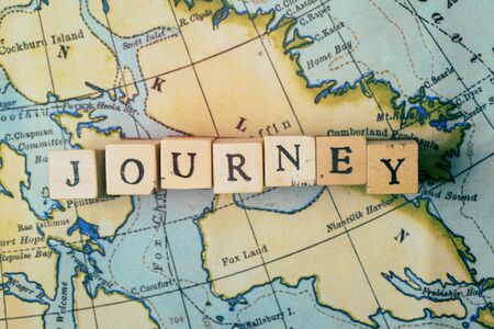 Journey word written in wooden blocks on a vintage travel mapの写真素材