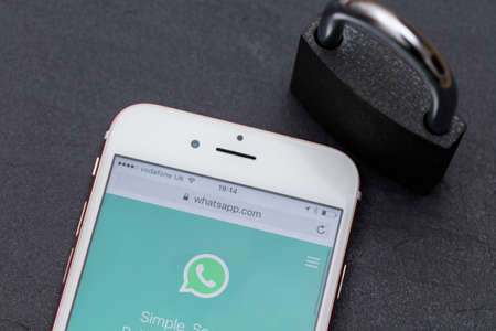 LONDON, UK - MARCH 2017: WhatsApp messaging app on a smartphone with a padlock.