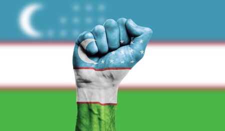 Uzbekistan flag painted on a clenched fist. Strength, Protest conceptの写真素材
