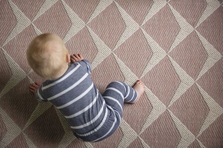 Overhead view of a 7 month old baby as they try to crawl for the first time