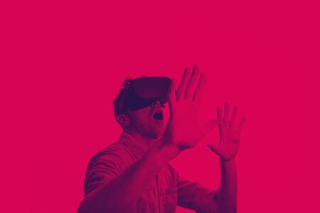 Man in his 30's wearing a VR virtual reality headset. Graphic duotone style