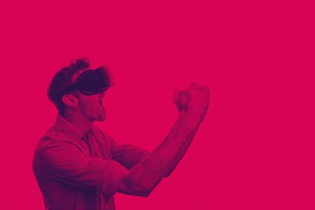 Man in his 30's wearing a VR virtual reality headset. Graphic duotone styleの写真素材