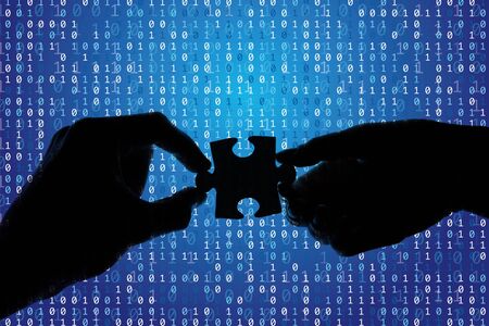 Silhouette of a hands holding a jigsaw puzzle piece with binary background