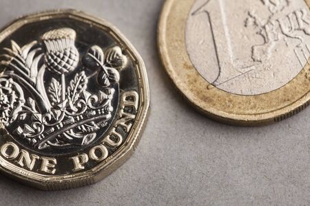 British one pound coin and one euro coin. Exchange rate conceptの写真素材