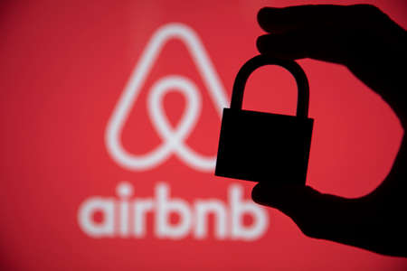 LONDON, UK - May 15 2020: Airbnb home holiday rental logo with security padlock