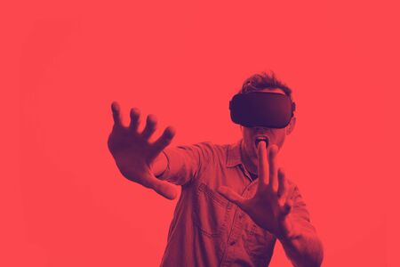 Man in his 30s wearing a VR virtual reality headset. Graphic duotone styleの写真素材