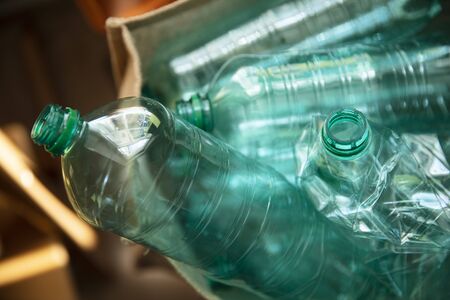 A collection of used green plastic bottles ready to be recycled