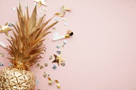Flat lay tropical pineapple and confetti party celebration backgroundの写真素材