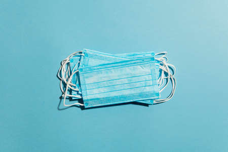 Blue surgical medical mask lay flat composition. healthcare concept
