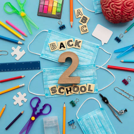 Back to school concept. School supplies with a medical face maskの写真素材