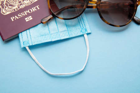 Summer travel during outbreak. Passport with face maskの写真素材