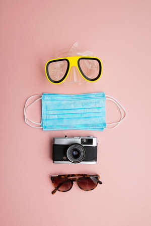 summer travel background. Medical mask with holiday itemsの写真素材