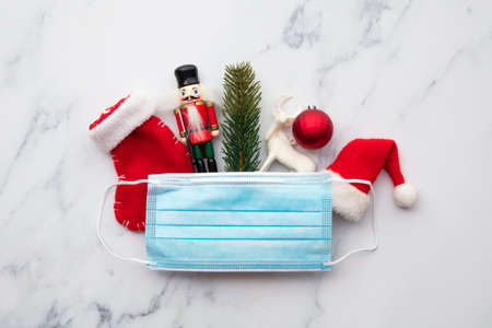 Covid-19 festive background. Face mask with christmas decorations