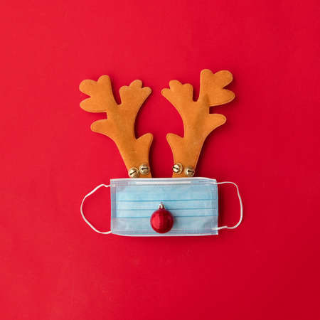 Festive christmas reindeer made from face mask and decorationsの写真素材