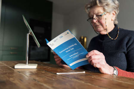 OXFORD, UK - February 2020: A woman reads the government Covid-19 home test kit