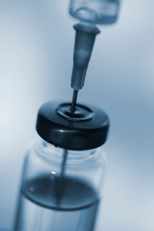 Close up of a medical injection needle in a vaccine vial doseの写真素材