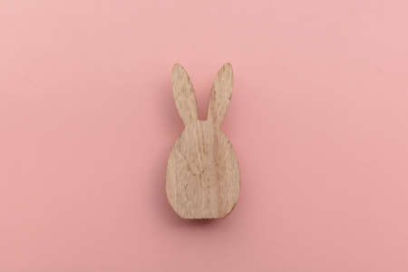 Minimal easter holiday background. Wooden easter bunny on pinkの写真素材