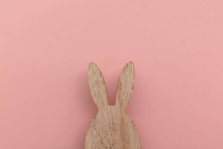 Minimal easter holiday background. Wooden easter bunny on pinkの写真素材
