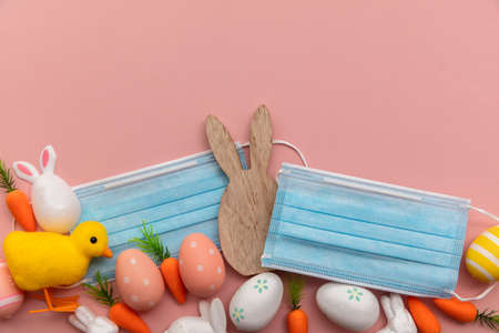 Easter springtime coronavirus background. Protective face mask with easter decorations